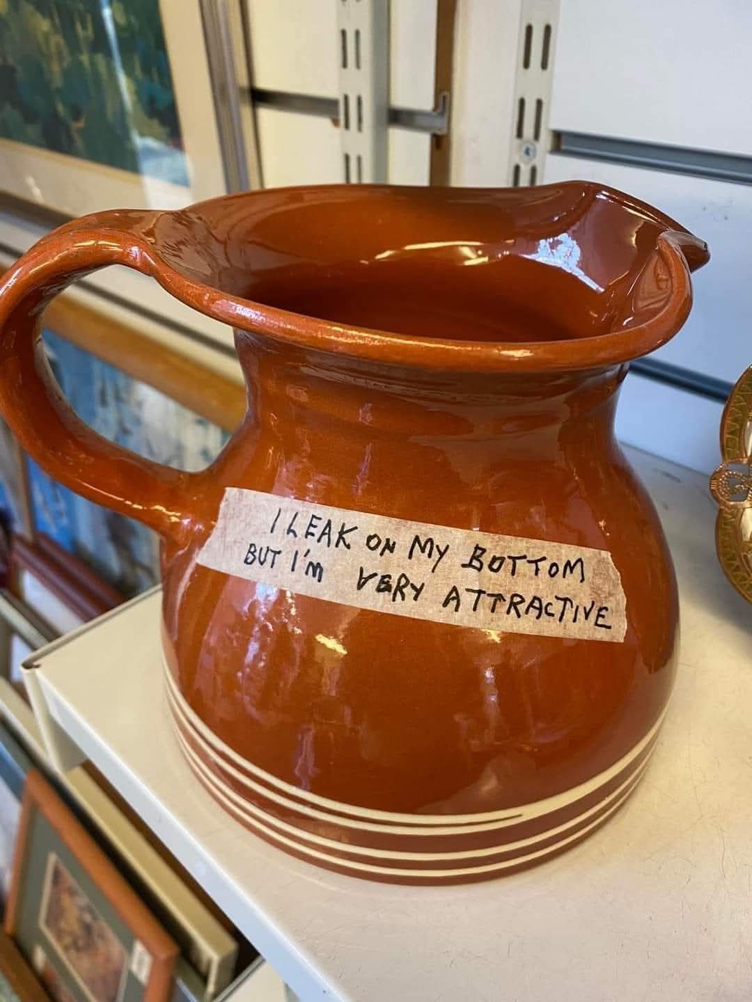 Ceramic pitcher labeled "I leak on my bottom but I'm very attractive" Ceramic pitcher labeled "I leak on my bottom but I'm very attractive"